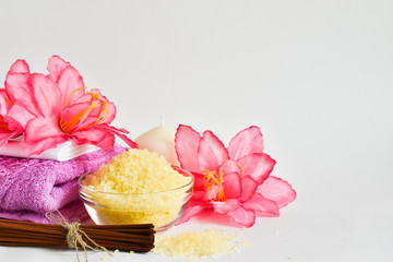 Pink flowers, towel, scented candles for taking a bath on a white background. Place for text