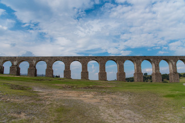 Fototapeta na wymiar Aqueduct Los Arcos Tepotzotlán, Mexico October 07 2018 A wide arched passageway in the back of the complex leads to the extensive gardens area of more than 3 hectares, filled with gardens,