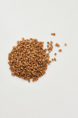 fenugreek scattered on a white background