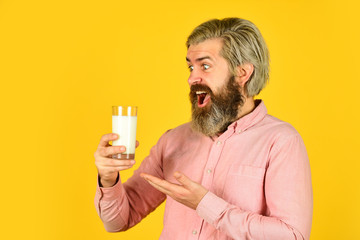 Fototapeta premium Pasteurized milk. Vegan milk concept. Vegan milks made from wide variety of beans nut, seeds and grains. Healthy food. Drink protein cocktail. Lactose free. Emotional bearded man hold glass of milk