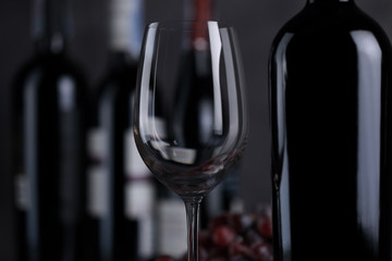 Wine glasses with bottles placed on a wooden floor and a beautiful backdrop are ready for parties.