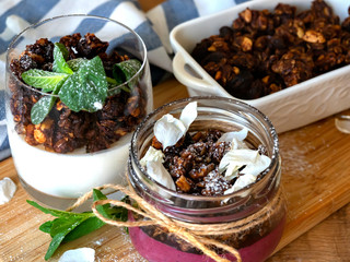 two desserts in a glass. Berry-curd dessert with granola. On a wooden board. 