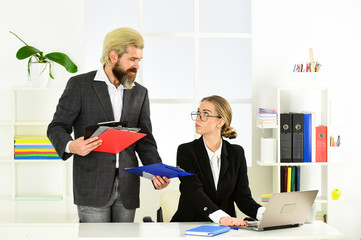 Modern gadget. explain ideas at workplace. business colleagues in modern office. mentor coach speaking to assistant. woman and man discuss work issues. colleagues brainstorming in talk chatting