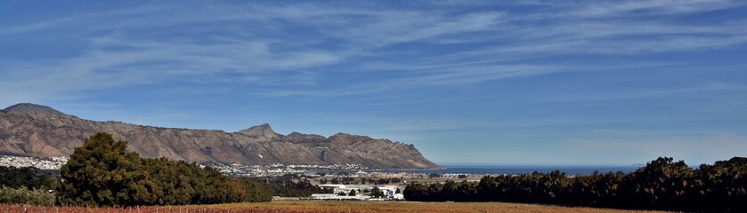 Landscape with vineyards and Gordons Bay with Mountains in autumn