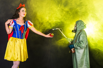 Woman dressed as fairytale character holds Radioactive atomic nuclear ionizing radiation danger...