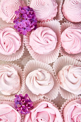 Violet sweet homemade marshmallow from blackcurrant near lilac flowers