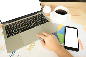 Close up hand of women using laptop for making plan of business and gedget on wooden table