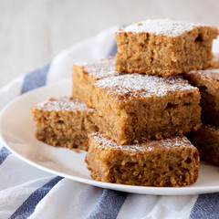 Homemade Tasty Applesauce Cake on a white plate, low angle view. Close-up.