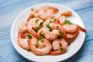 Fototapeta na wymiar Shrimp delicious seasoning spices on white plate and wooden table background cooked shrimps or prawns , Seafood shelfish