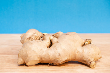 Ginger fresh on blue background. concept healthy spice diet
