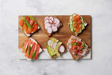 Bruschetta with toppings on the light background