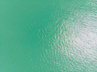 Fototapeta na wymiar Sea surface aerial view with sun reflection.