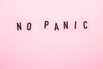 The inscription no panic on a pink background close-up. - obrazy, fototapety, plakaty