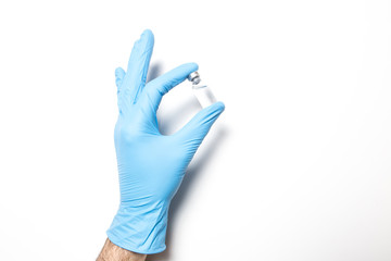 Male hand in a medical glove with a vaccine on a white background.