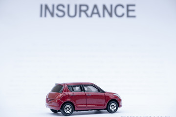Car placed on insurance documents. Car insurance concept