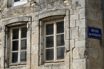 Old building and street sign in La Rochelle