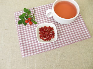 Obraz na płótnie Canvas Red rose hip tea, fruit tea from rosehip peel
