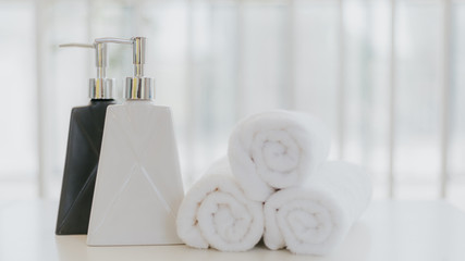 Shampoo and shower cream bottle with towel