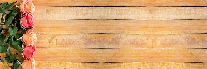 Handmade roses layout on wooden background. Background layout with free text space.