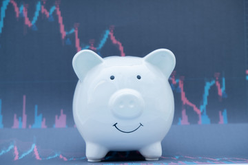 White color piggy bank on share document  analyze the plans regarding the stock business investment