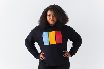 Beautiful African American woman posing in black sweatshirt on a white background. Fashion photo...