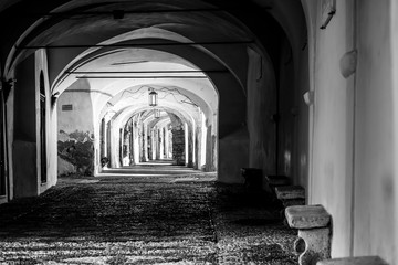 Obraz premium black and white photo of an arcade in the medieval town of Noli, Savona, Italy
