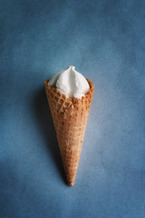 ice cream cone against blue background, film grain effect