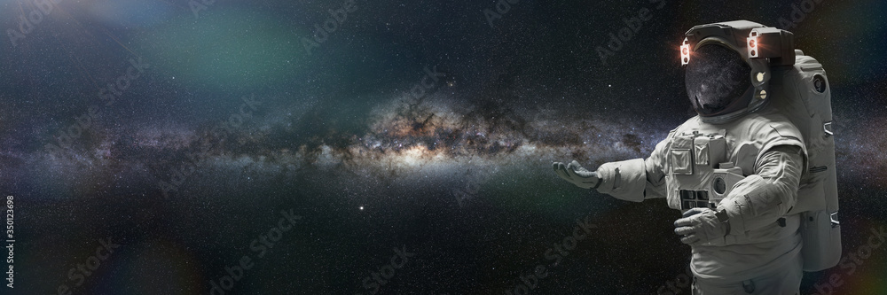 Poster astronaut presenting an empty space in front of the milky way galaxy