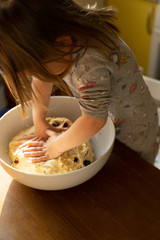 children cooking, little girl baking bread, knead the dough, sprinkle flour