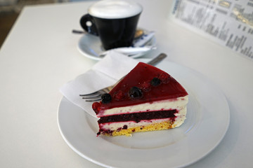 Close up Blueberry cheese pie served with a cup of hot cappuccino coffee