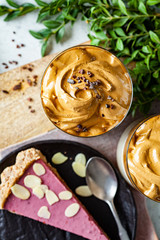 Cold dalgona coffee. with fruit cake, top view.  Drink with cold milk and coffee cream foam in glasses.