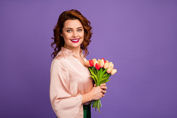 Profile photo of charming pretty chic lady hold bunch of fresh tulip flowers 8 march party receiving present toothy smiling wear luxury beige shirt blouse isolated purple color background
