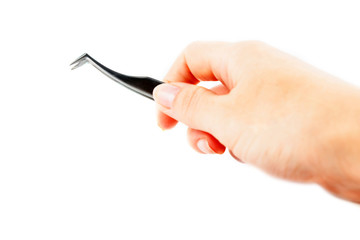 Metal tweezers isolated on a white background. Body care concept. Creative background, copy space.