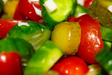 Vegetable salad sliced tomatoes, cucumbers, onions and pickles. Close up. Healthy food, fitness diet.