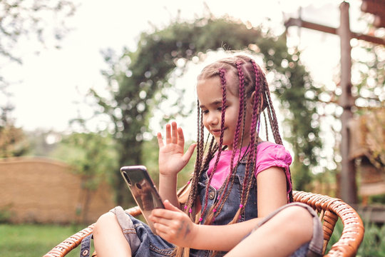 Girl chatting with friends with smartphone, virtual game during lockdown and after, new normal