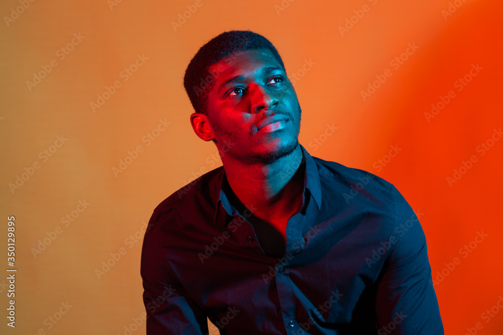 Wall mural face african american stylish man posing on the blue and red neon light background. - Wall murals
