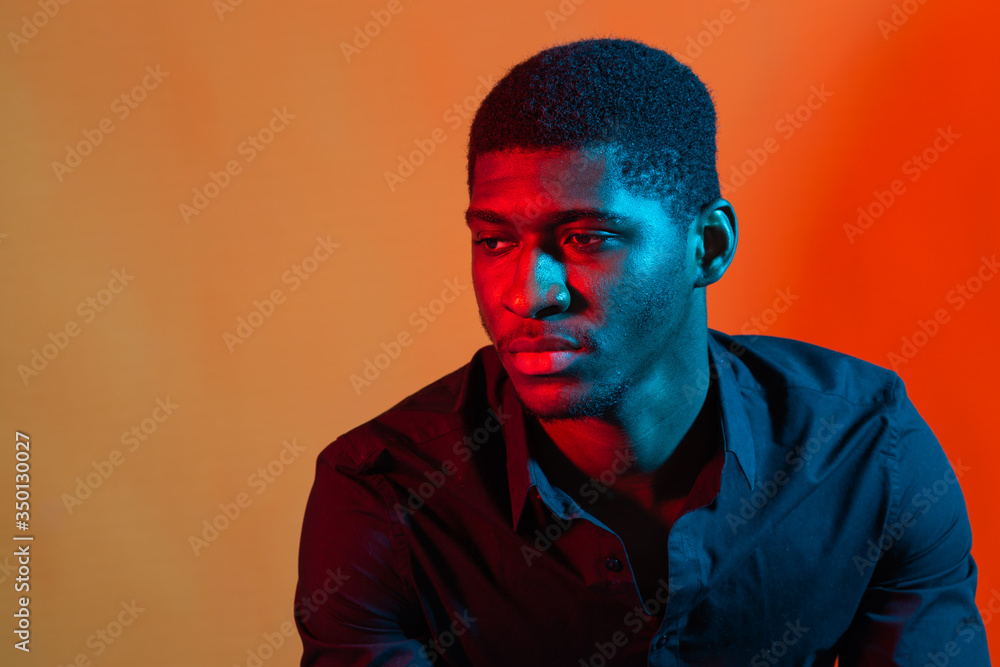Wall mural Dark neon portrait of young man wearing in shirt. Red and blue light. Technology - Wall murals