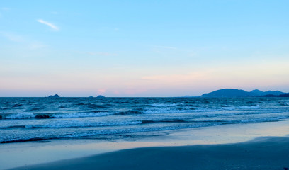 The sea at sunset when there are small waves and beautiful evening views.