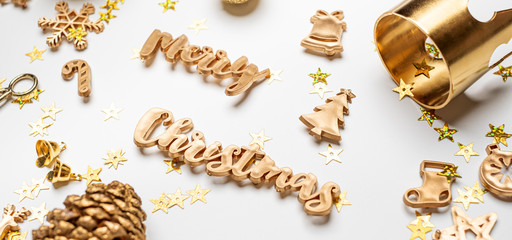 merry Christmas gold  shiny text with luxury xmas decoration items on white table.happy new year holiday concept