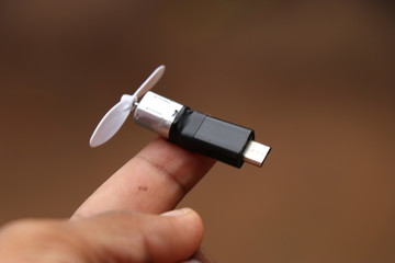 Smartphone powered mini fan with plastic blades and coreless motor