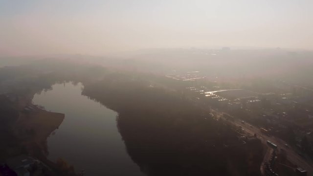 Aerial view of Prague's Prirodni park Sarka Lysolaje in the early morning, sunny, misty lake from drone, Czech republic