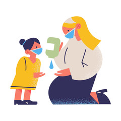 Mother and daughter wearing protective medical masks and using sanitizer