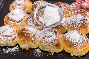 bakery fresh bun dusted powdered sugar. closeup