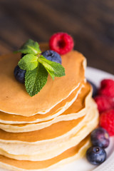 Homemade american pancakes with fresh blueberry and raspberries. Healthy morning breakfast. Rustic style
