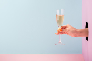 Woman's hand holding a glass of champagne