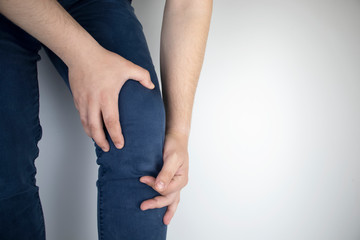 A man suffers from knee pain. Examination by an orthopedist and traumatologist. Redness and swelling of the legs, torn meniscus or knee bursitis
