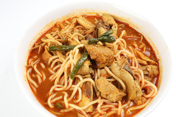Malaysian curry yellow mee noodle with roasted chicken slice in white bowl on white background