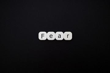 Alphabet fear word block with black background.
