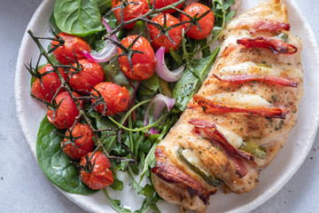 Baked hasselback chicken breast stuffed with bacon, cheese and jalapenos