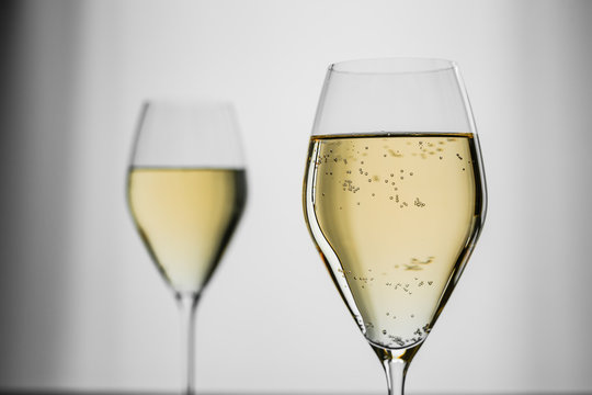 White Sparkling Wine In A Beautiful Glass On Grey Background